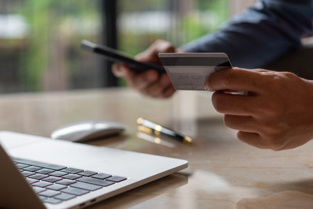 man hands holding credit card using internet payment laptop computer, online shopping digital banking, Business financial technology concept.の写真素材