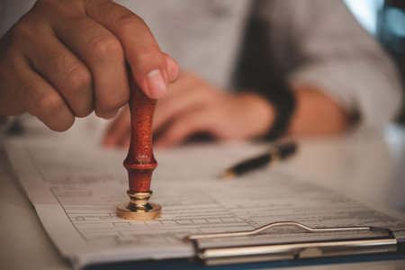 businessman hand stamping approved on certificate document contract in office. Lawyer stamping...