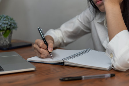 Businessperson reading and writing on book.education studying knowledge development and cognition learning concept.の写真素材