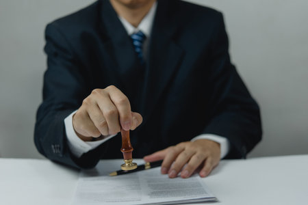 Contract law or paper work business and finance document rubber stamp. For official and legal contracts and agreements, financial statements, investment contracts, real estate documents.の写真素材