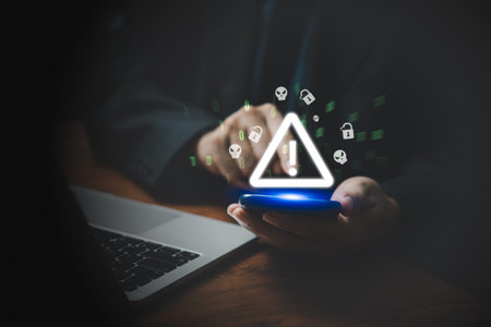 Businessman using mobile smartphone and computer laptop with triangle caution warning sing. Failure Attacked Hacked Virus Abound Concept. Problem for notification error 404.の写真素材