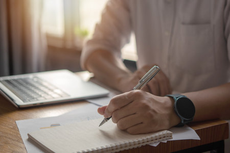 Hands Writing with Pen on Notebook. concept of work, study, and education.の写真素材