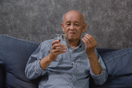 Asian elderly man takes his medicine, showing that taking care of his healthcare.の写真素材