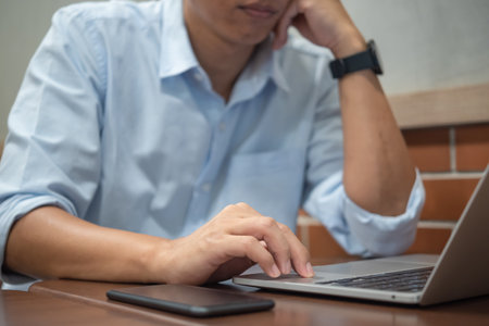Person hands typing on laptop keyboard at the office. Business man hands typing online learning, internet marketing, searching the information and technology concept.の写真素材