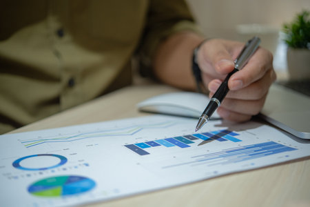 Business person working with financial documents analyzing. business investment information, financial and tax system planning and business strategies concept.の写真素材