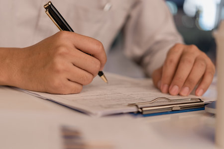 Business person Writing contract law and paper work for business and finance investments , write document, complete job application forms concept.の写真素材