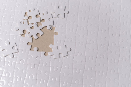 Puzzle pieces on background.white jigsaw puzzle pieces copy space for text, top view.の写真素材