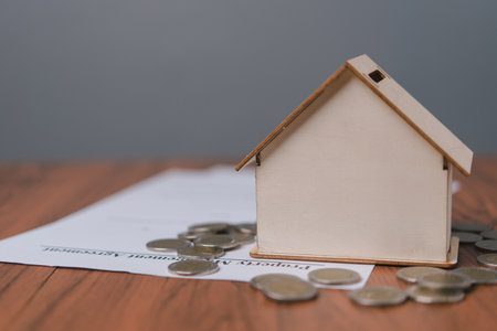 House and coins stack on the contract document. Home sales and home insurance concept.home loan.Property investment and house mortgageの写真素材