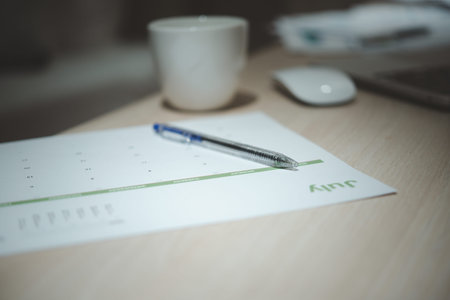 Calendar, Papers, and Pen on Table for Productivity and Time Management Planning and Business...