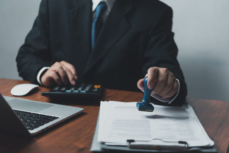 Businessman Stamping Approval on Work Documents Investment Corporate Finance Management and Marketing at Office Desk.の写真素材