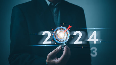 2024 calendar business planning target and strategy growth success innovation. Creative thinking idea marketing finance investment concept.Hand holding lightbulb.の写真素材