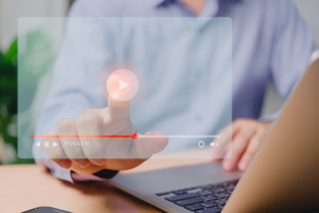 Man streaming live content on virtual screen via laptop for online concerts, shows, tutorials, and...