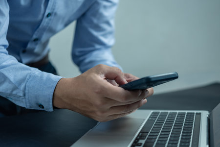 Business man using mobile smart phone management information financial documents, marketing online, job and payment digital technology on desk.の写真素材