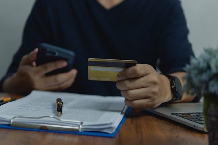 Man holding credit card and mobile phone payment financial internet banking online. Business...