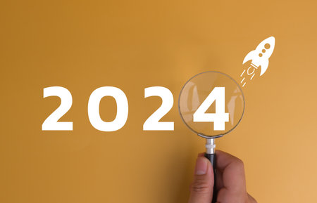 New Year 2024 business planning and strategy concept. Business start up target, marketing financial and research analysis, investment Magnifying glass on background with a number.の写真素材