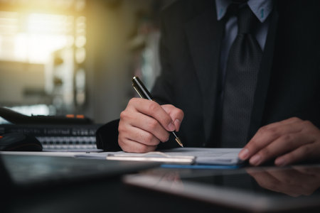 Business person Writing contract law and paper work for business and finance, write document, complete job application forms, contract real estate and insurance concept.の写真素材