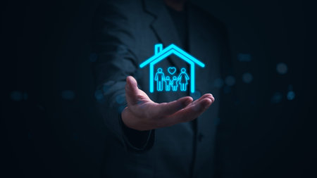 Hand presents a glowing hologram of a family within a house, symbolizing concepts of protection, security, and home insurance. estate real investment and financial business.の写真素材
