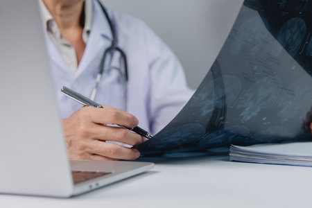 Expert doctor reviewing magnetic resonance images.の写真素材