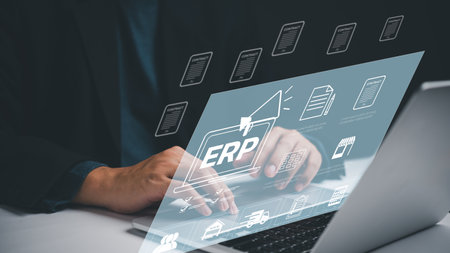 A person is typing on a laptop with ERP Enterprise Resource Planning on the screen. Concept job management marketing data analysis businessの写真素材