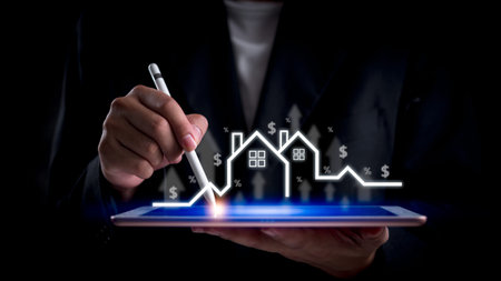 Businessman analyzing real estate market growth on digital tablet. Represents property investment, housing market analysis, financial planning. Ideal for real estate, economic strategy visuals.の写真素材