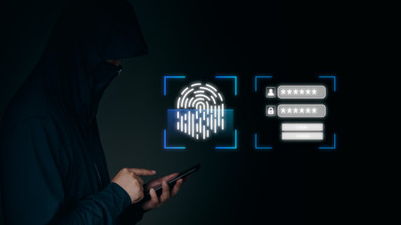 Hacker using a smartphone to attempt bypassing biometric fingerprint authentication and passwords. Represents online identity theft and cybersecurity risks.の写真素材