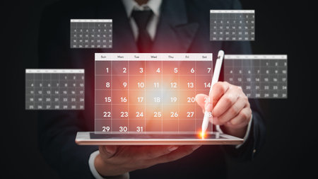 Hand managing a digital calendar on a tablet, showcasing efficient scheduling. Perfect for productivity and business planning visuals.の写真素材