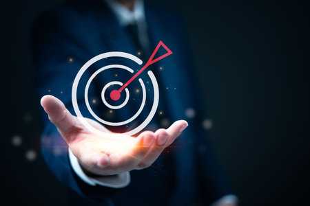 Hand presenting a target symbol with an arrow, representing goal achievement and strategic focus. Ideal for business, marketing, and performance analysisの写真素材