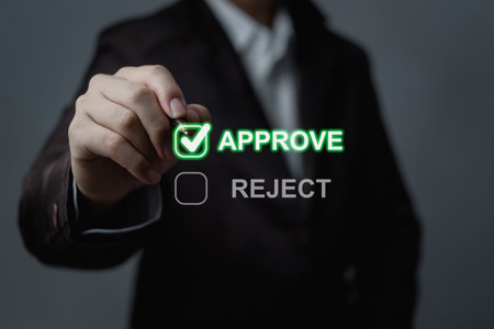 Business professional interacting with a digital approval system, emphasizing the approval and rejection process in decision-making.の写真素材
