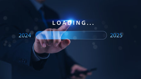 A hand pointing at a loading bar with a transition from 2024 to 2025 strategic planning, symbolizing progress and the future.の写真素材