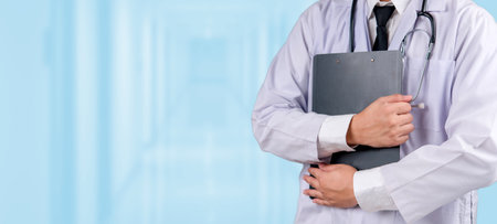 Doctor holding a clipboard check up report, standing in a hospital hallway. Medical healthcare services, clinical expertise, patient care, hospital environment, and healthcare industry.の写真素材