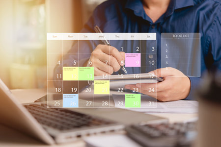 businessman planning his tasks using a calendar and to-do list on a smartphone. Efficient time...