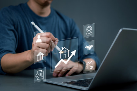 Man using digital pen to visualize real estate market trends, drawing growth charts and financial graphs, business strategy, and property investment analysis.の写真素材