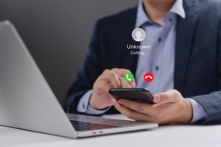 Close-up of a smartphone showing an incoming call from an unknown number. Perfect for office communication, digital communication, and mobile business use visuals.の写真素材