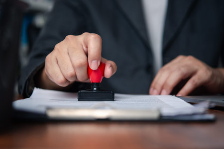 Businessman stamping document to approve official contract, concept of legal authorization and...