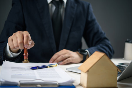 Businessman stamping approved on real estate contract. Concept of property agreement, mortgage...