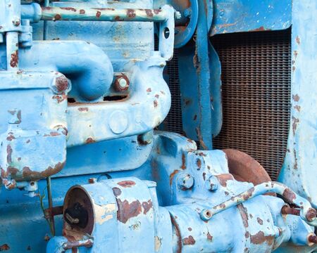 Rusted Blue tracktor engine close-up for a backgroundの写真素材