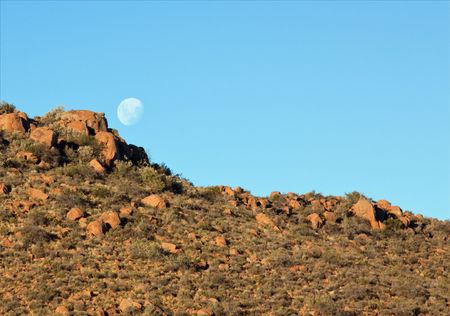 Moon rising over Karoo hill in the late afternoonの写真素材