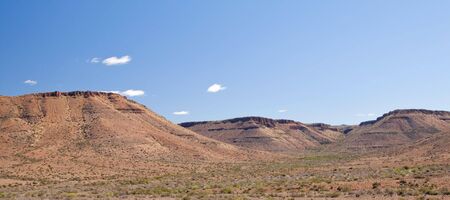Desolate Panoramic Landscape of the arid Karoo with a bright blue skyの写真素材