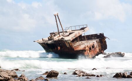 Aghullas shipwreck lying on the rocks in the breakersの写真素材