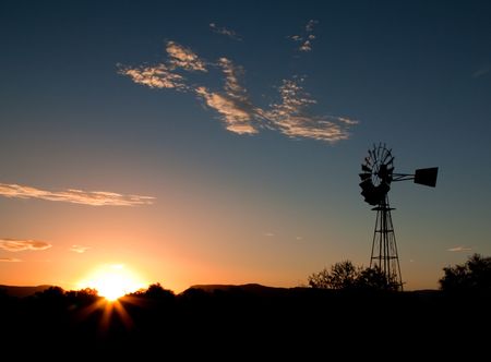 Silhouette of a Windmill at sunset in the Karooの写真素材
