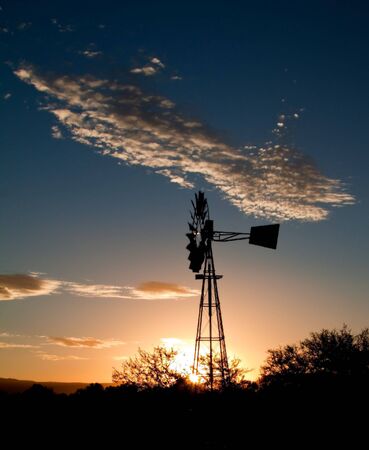 Silhouette of a Windmill at sunset in the Karooの写真素材