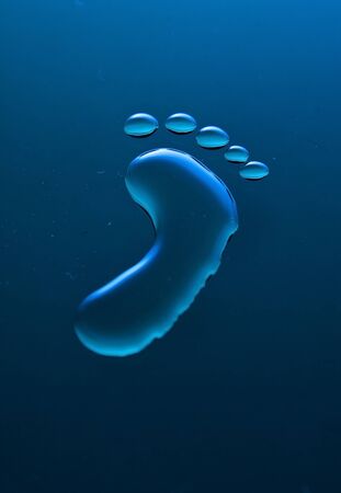 One blue footprint out of water on blue surfaceの写真素材