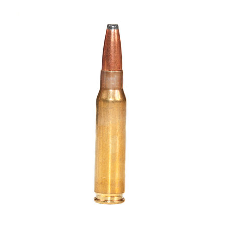 Single rifle bullet ready to be fired standing on a white surface