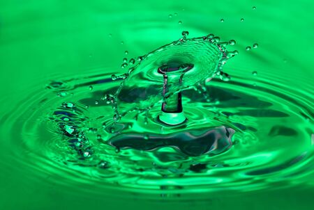 Two waterdrops that collide creating an umbrella effectの写真素材