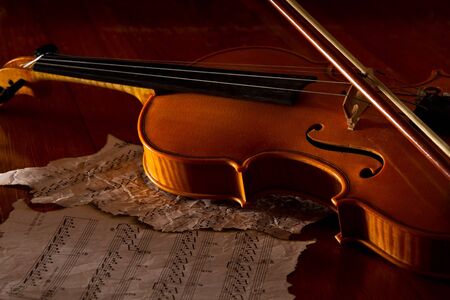 Violin sheet and music on wooden floor with soft lightの写真素材