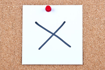 Post it note on wood in white with wrong cross