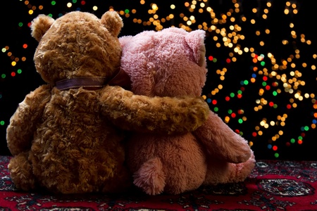 Teddie bear with white with red rose sitting with bokeh backgroundの写真素材