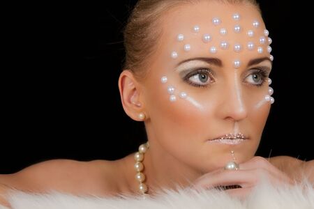 Lovely blond woman portrait with creative make-up and white spotsの写真素材