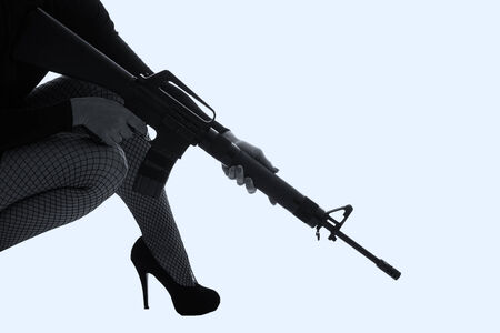 Dangerous woman in black with assault rifle artistic conversionの写真素材