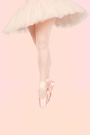 Ballet dancer standing on colourful floor while dancing in pink tutu artistic converion